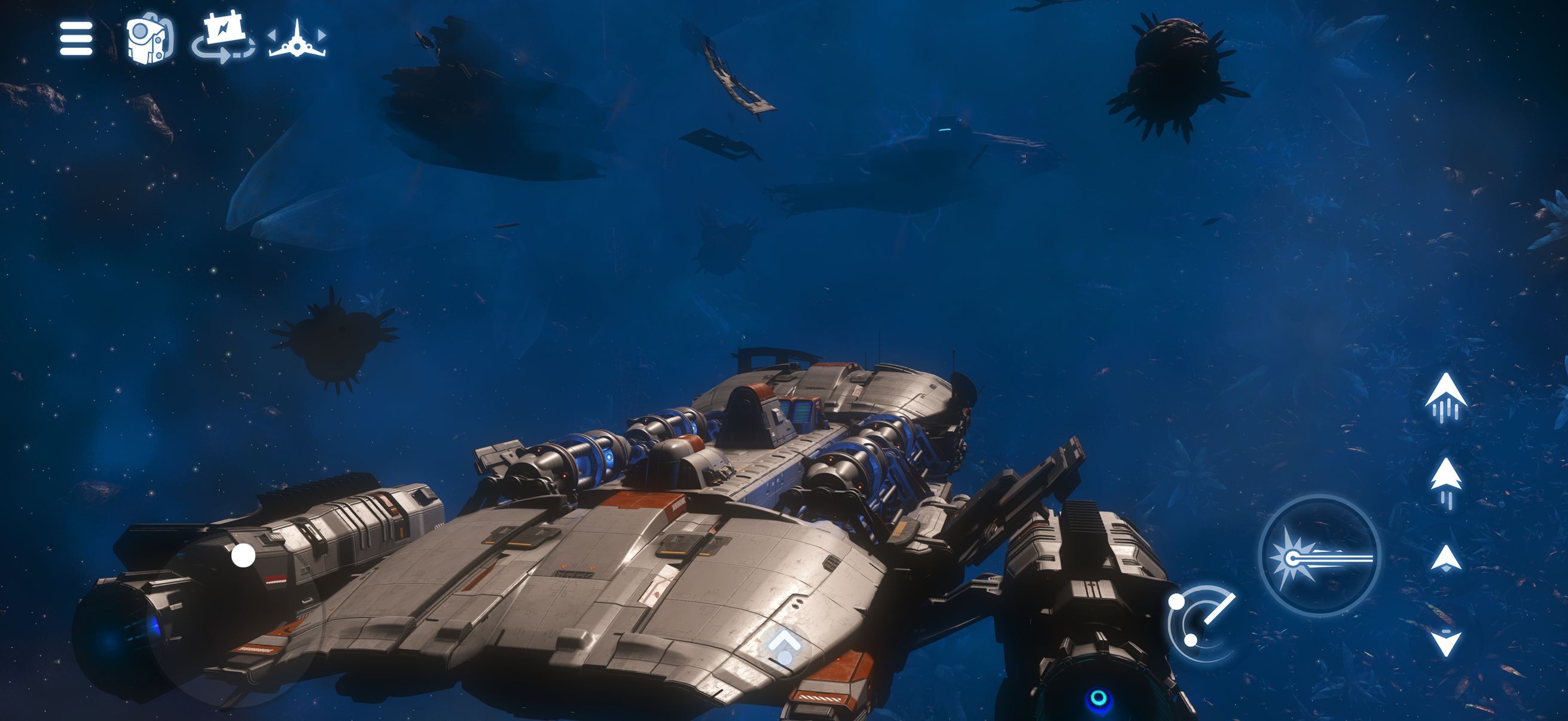 A heavily armed starship hangs in a dark blue debris field among drifting alien hulks, with touch flight controls along the right edge of the screen