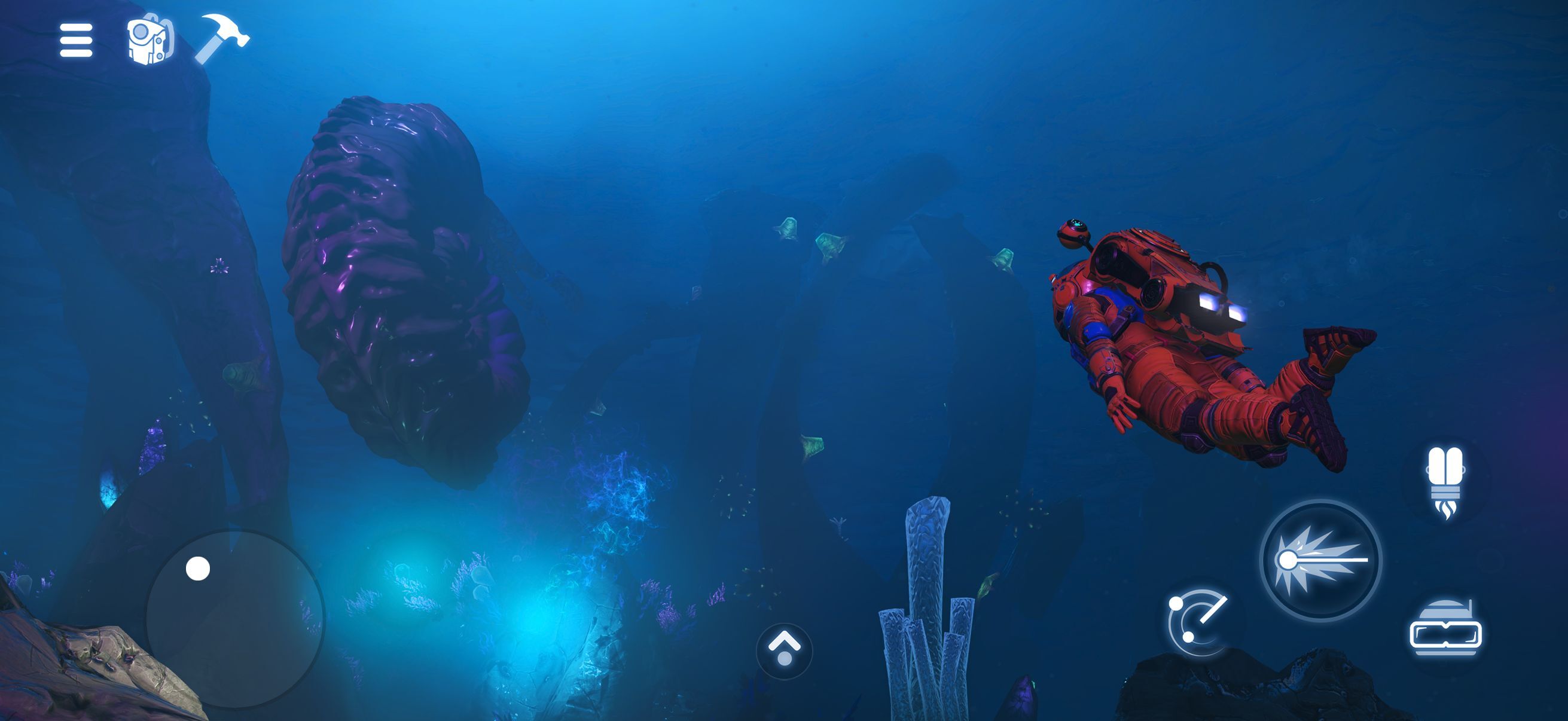 An astronaut in an orange exosuit swims through a glowing blue underwater cave past a huge purple rock formation, with a virtual joystick and action buttons on screen